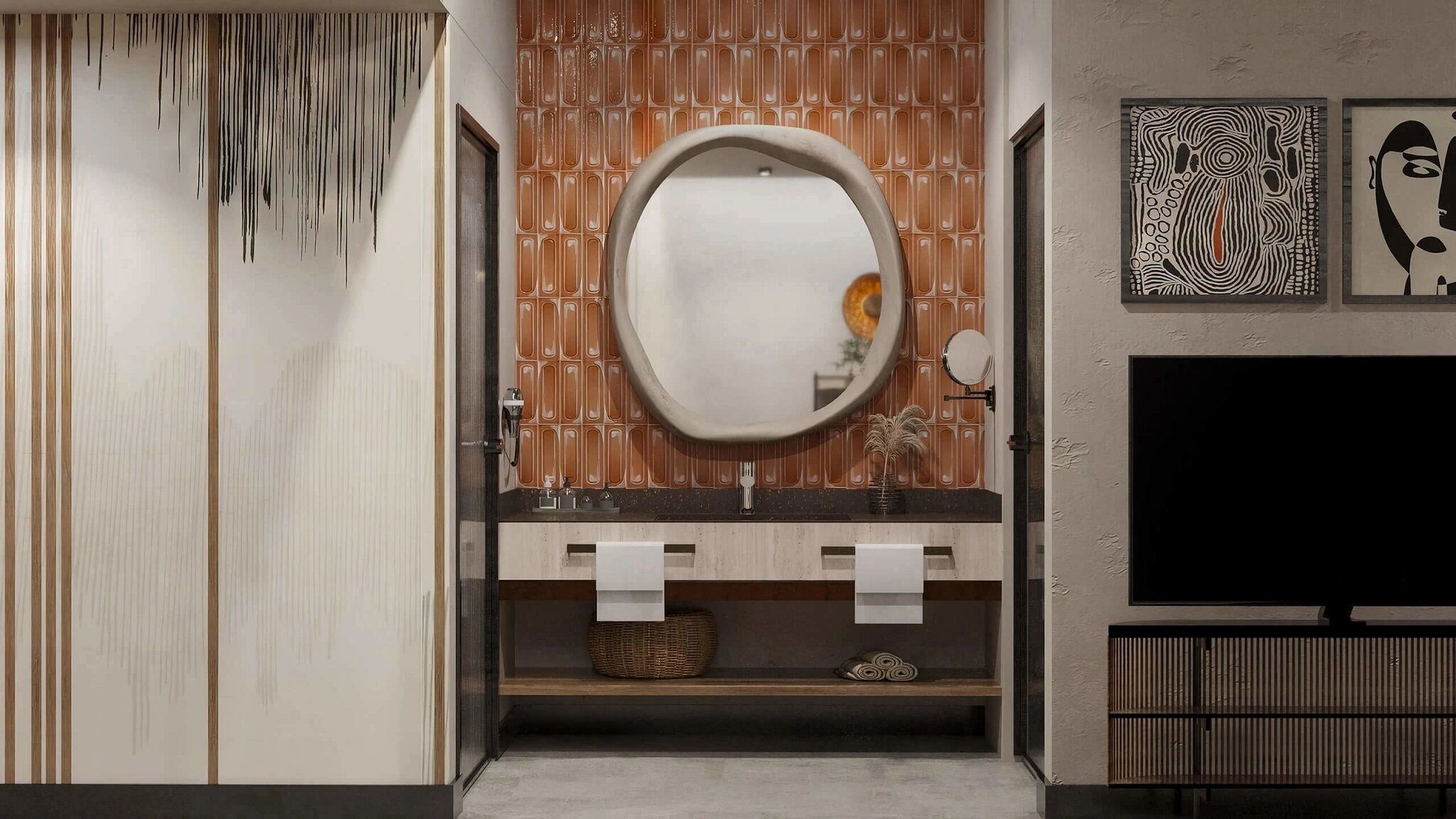 A modern bathroom with a wooden vanity, a round mirror, and a flat-screen TV mounted on the wall.