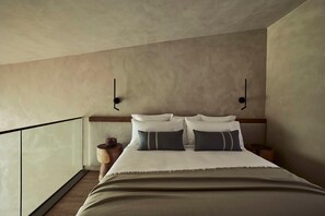 A bedroom with a bed, bedside tables, and a view of the balcony. - Zelia Halkidiki (Nea Propontida)