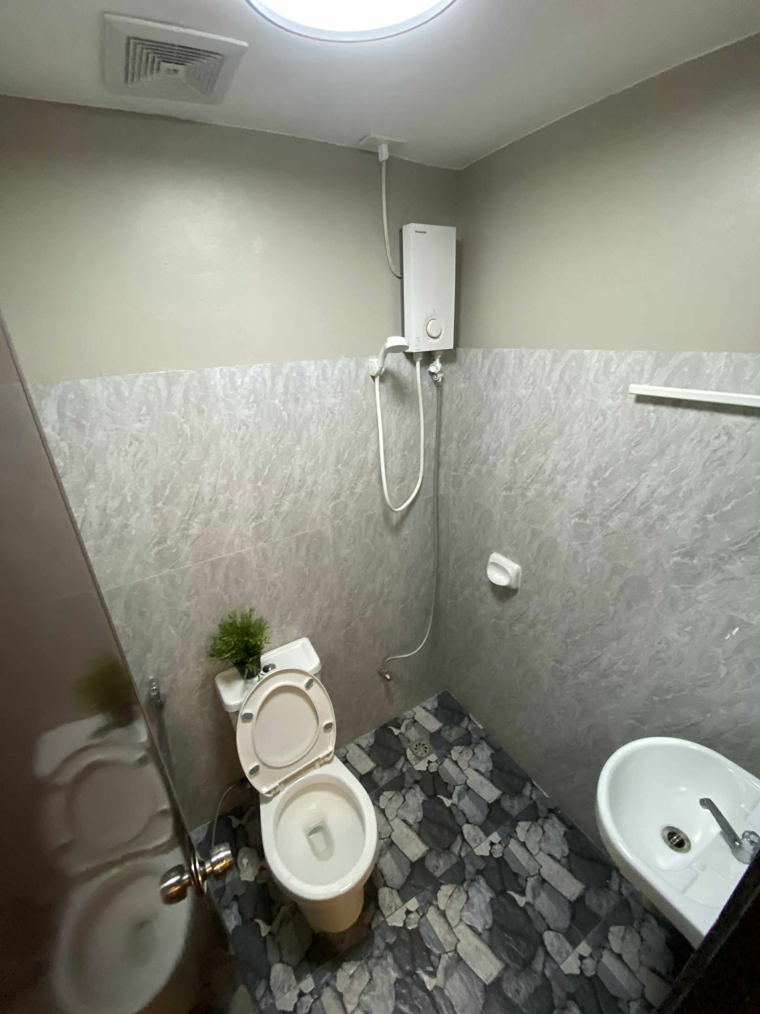 A small bathroom with a toilet, bidet, and sink.