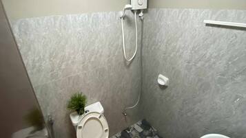 A small bathroom with a toilet, bidet, and sink.