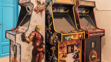 Three arcade machines with character-themed artwork.