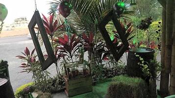 A tropical-themed outdoor area with various plants and decorative elements.