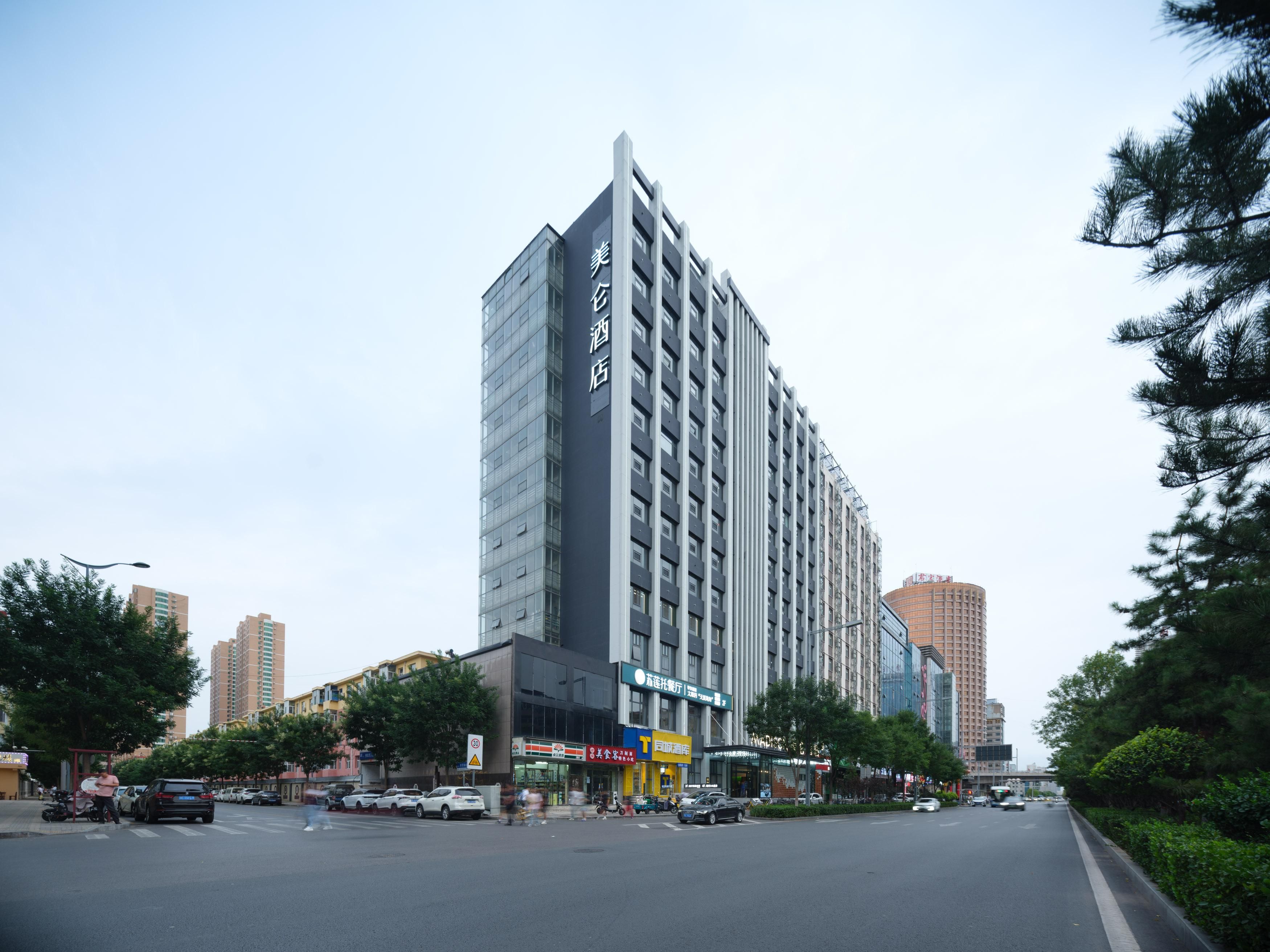 A modern hotel with a prominent vertical facade, multiple floors, and a large entrance.