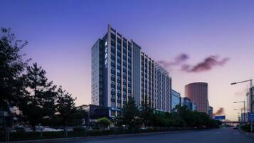 A high-rise hotel with multiple floors, a modern architectural design, and a prominent entrance.