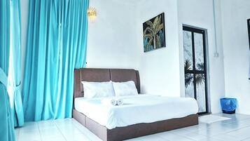 A modern bedroom with a large bed, a view of palm trees, and a door leading to an outdoor area.