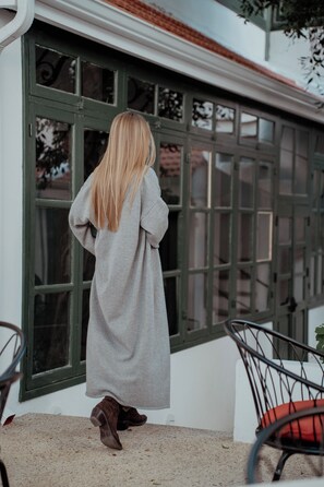 A person standing by a window with a view of a building. - Kentrikon 1924 Boutique Hotel And Suites (Paphos)