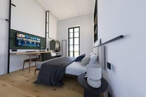 A modern bedroom with a bed, bedside table, and a desk with a computer. - Kentrikon 1924 Boutique Hotel And Suites (Paphos)