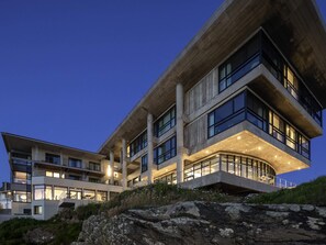 A modern multi-story building with large windows and a curved balcony. - Sainte-barbe Hotel Spa Le Conquet-mgallery Collect (Le Conquet)