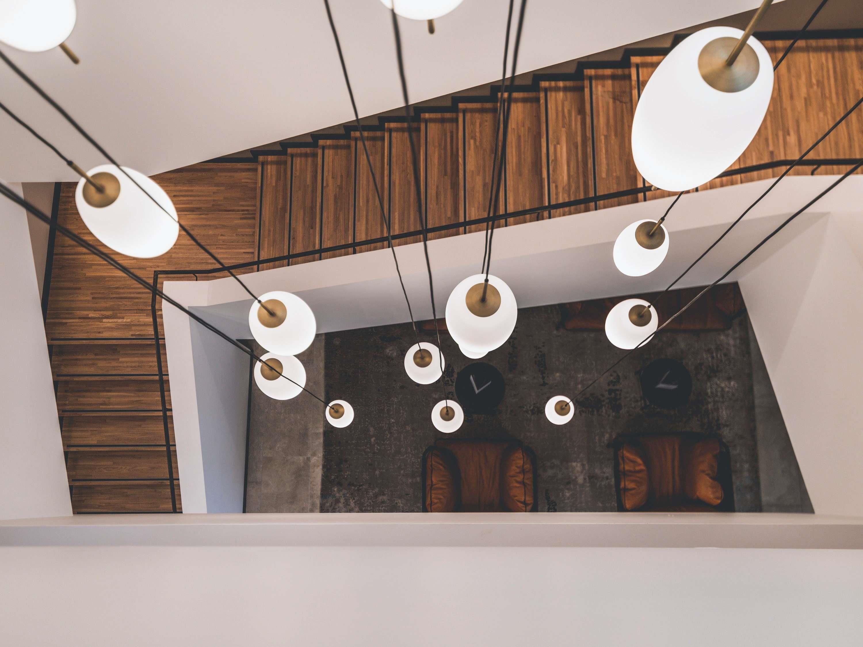 A modern interior with a wooden ceiling and a concrete wall with circular cutouts.