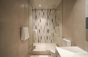 A modern bathroom with a glass shower enclosure, a toilet, and a sink. - Sesaya Poshtel & Bistro (Sri Jayawardenepura Kotte)