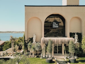 A building with a sign reading 'The Local House' and a view of the sea. - L'saranda House Cesme (Çeşme)