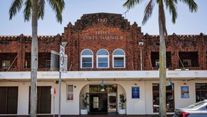 Hotel Coffs Harbour with a brick facade, a sign indicating 1937, and a bistro on the right.