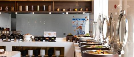 A buffet area with various food stations and a selection of beverages.