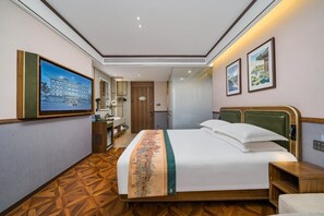 A hotel room with a bed, a desk, a chair, a mirror, and a wall-mounted TV. - Nostalgia S Hotel(beijing Tianqiao (Beijing)