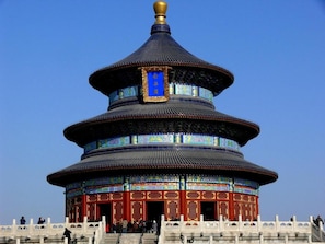 A multi-tiered pagoda-style building with a prominent golden finial, featuring intricate traditional patterns and a blue plaque. - Nostalgia S Hotel(beijing Tianqiao (Beijing)