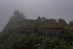 A building with multiple levels, surrounded by dense vegetation. - Mon View Ngarm (Chiang Mai)