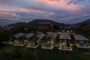 A resort with multiple bungalow-style accommodations, a central building, and a scenic hillside backdrop. - Mon View Ngarm (Chiang Mai)