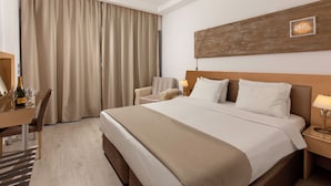 A hotel room with a large bed, a desk with a chair, a nightstand, and a wall-mounted artwork. - Kolymbia Bay Art Adults Only Boutique Hotel (Rhodes)