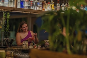 A bar area with various bottles and a person seated. - Kolymbia Bay Art Adults Only Boutique Hotel (Rhodes)