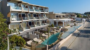 A multi-story hotel with balconies, a swimming pool, and a view of the sea. - Kolymbia Bay Art Adults Only Boutique Hotel (Rhodes)