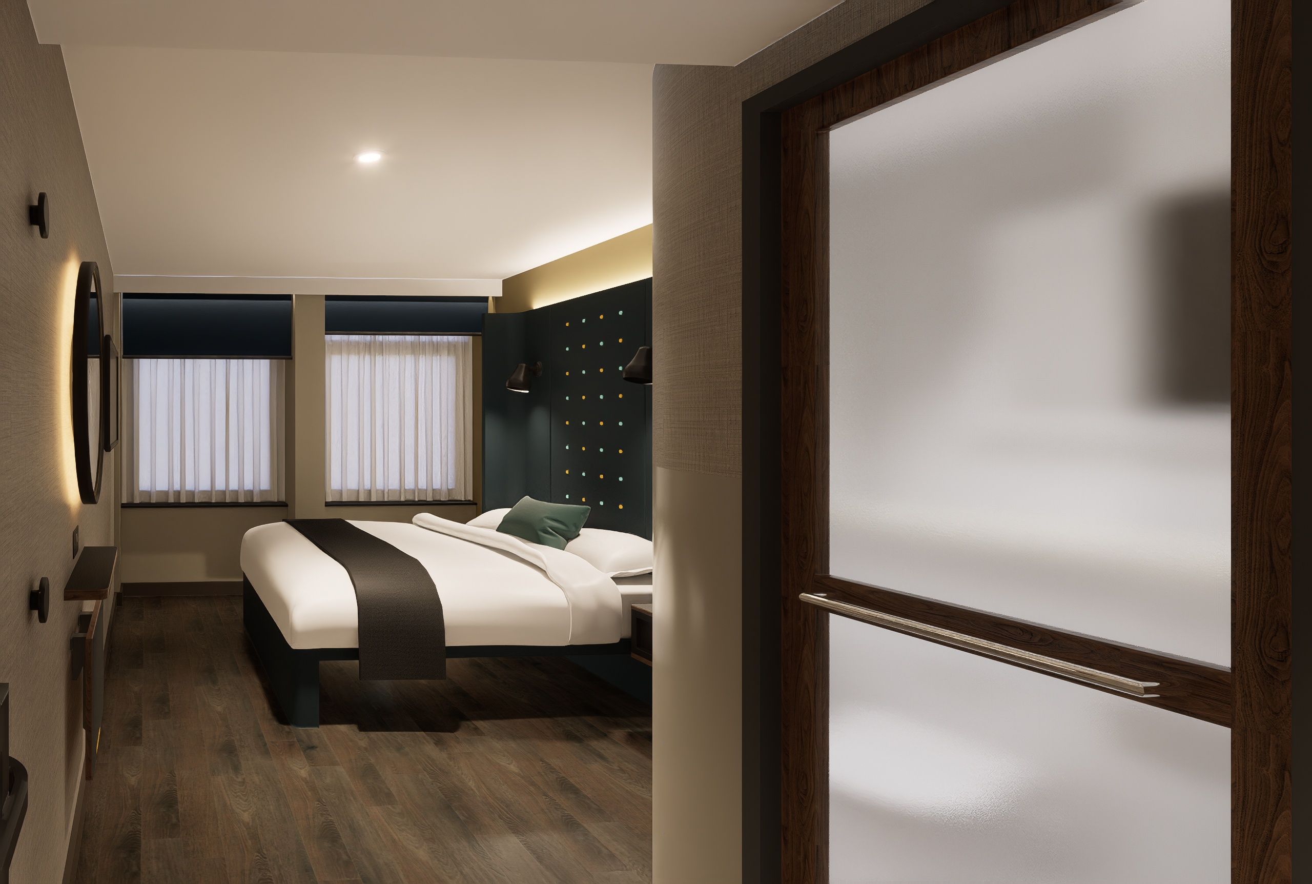 A modern hotel room with a bed, bedside tables, a wall-mounted light fixture, and a window with curtains.