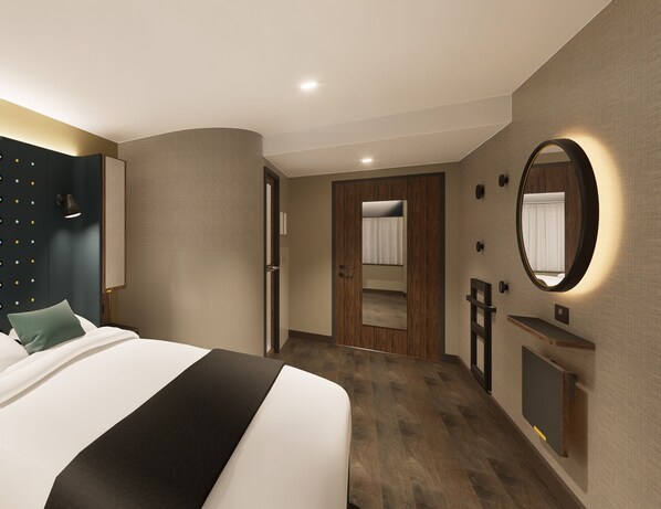 A modern hotel room with a large bed, a wooden door, a mirror, and a small desk. - Point A Hotel Edinburgh, St Andrew Square (Edinburgh)