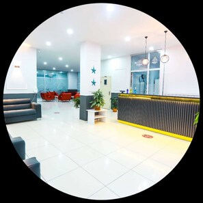 A modern reception area with a reception desk, seating area, and a glass wall. - Diera Family Hotel (Atakum)
