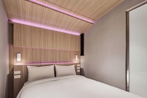 A modern hotel room with a wooden headboard, bedside lamps, and a large bed. - Orange Hotel - Hanzhong Taipei (Taipei)