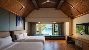 A hotel room with two beds, a desk, a television, and a large window with a view of the sea and palm trees. - Peridot By The Sea At Redang (Redang Island)
