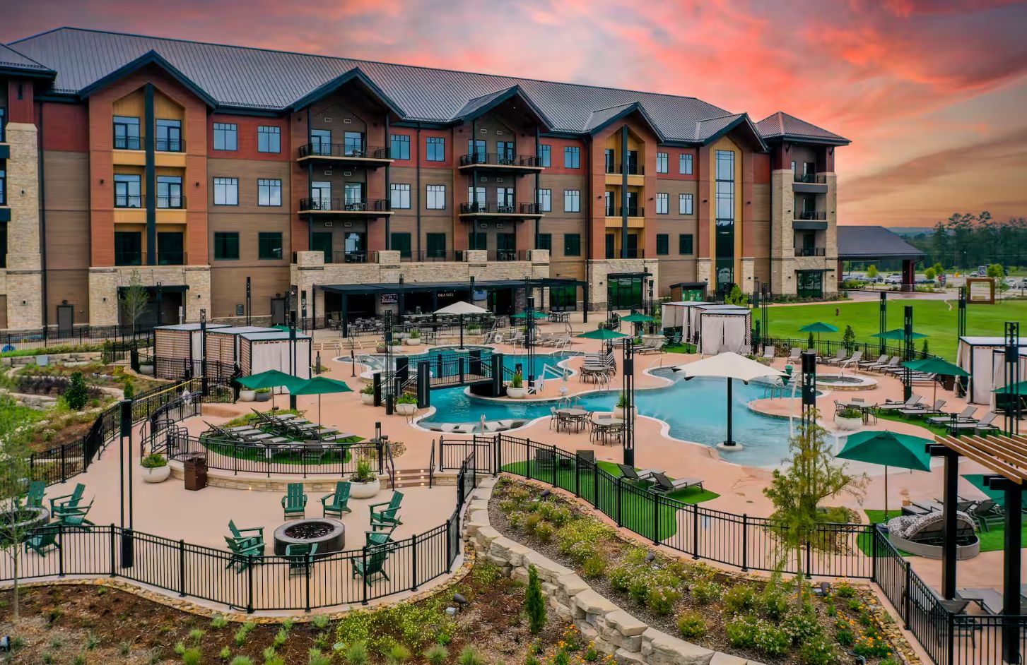 A hotel with multiple floors, outdoor swimming pool, and lounge areas.