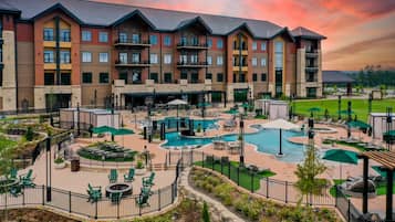 A hotel with multiple floors, outdoor swimming pool, and lounge areas.