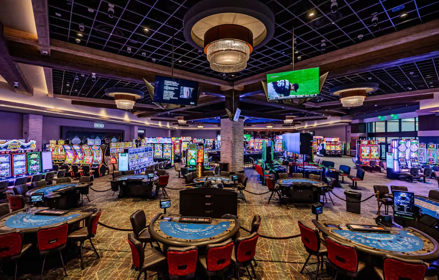 A casino with multiple gaming tables and slot machines.