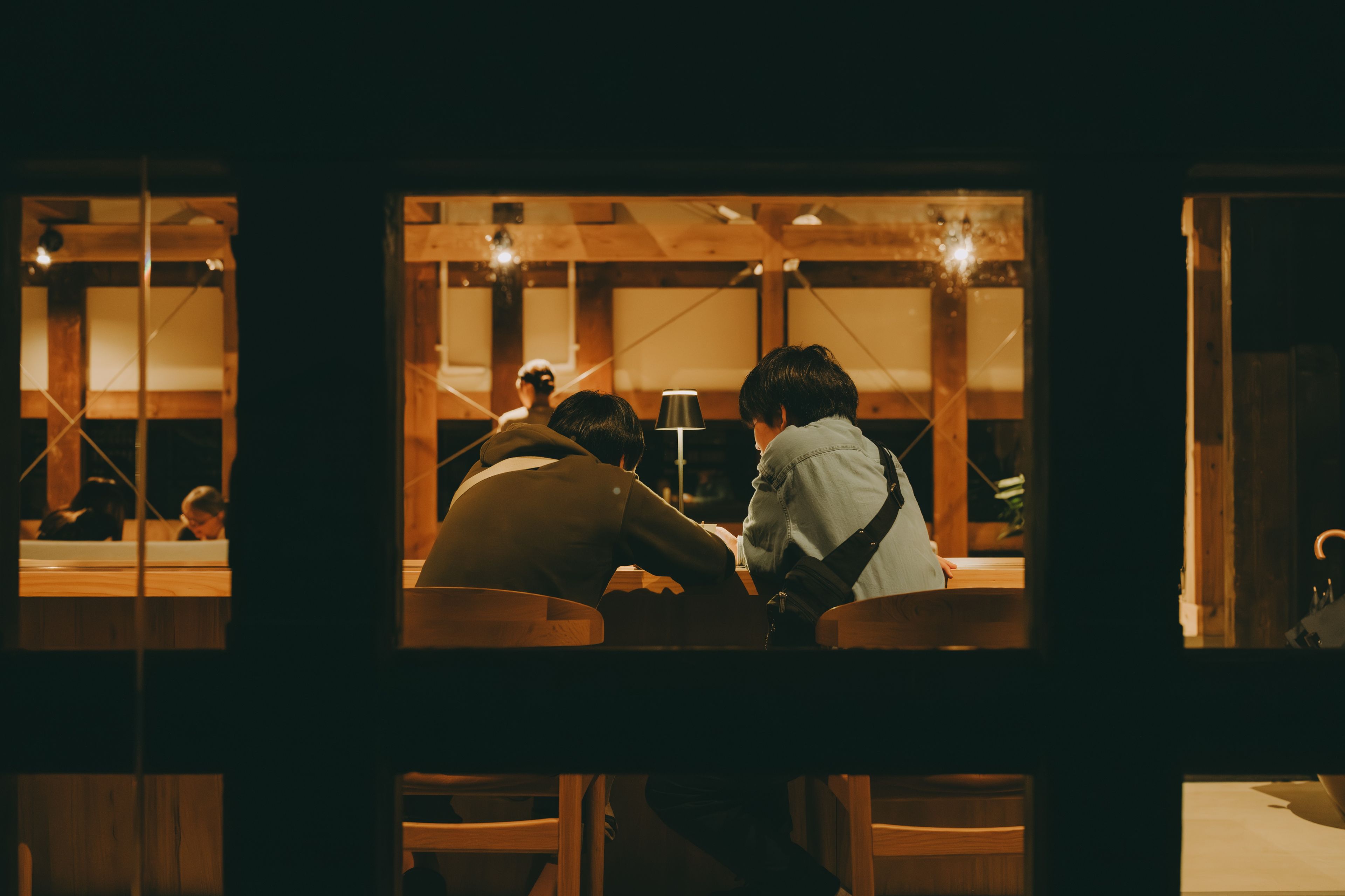 A dimly lit room with wooden furniture and a visible window.