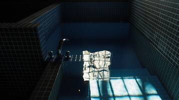 A tiled swimming pool with a faucet and a towel rack.