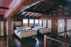 A room with two beds, wooden beams, and large windows. - Bon-yado Uakita Nishimonai (Ugo)