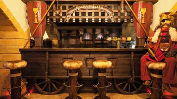 Eine bar im mittelalterlichen Stil mit hölzernen Barhocker und einem dekorativen Schild.