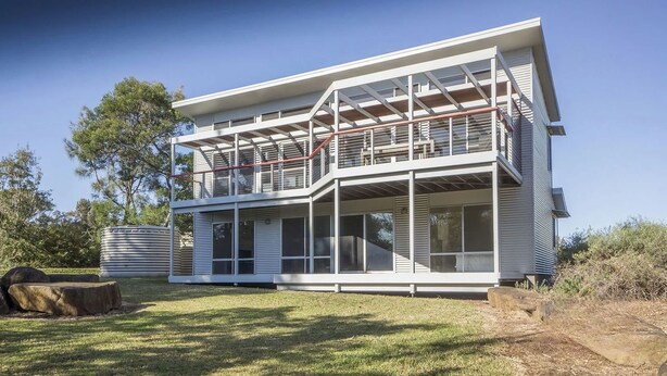 A modern two-story house with large windows and a balcony. - Anchor at Bawley Point (Bawley Point)