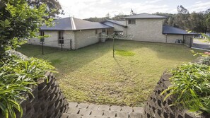 A residential property with a fenced backyard, a brick house, and a small attached garage. - Atlantis on Lake Conjola (Conjola Park)