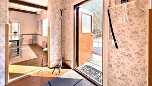 A room with a wooden door, a window, a chair, a table, and a rug. - 5 bedroom pet friendly home in Sjöbo (Sjöbo)