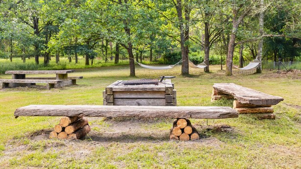 A rustic outdoor setting with a wooden bench, a hammock, and picnic tables. - 5 bedroom pet friendly home in Sjöbo (Sjöbo)