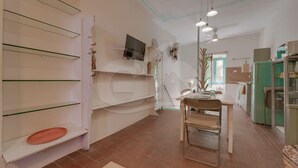 Eine Küche mit Esstisch, Stühlen und einem grünen Kühlschrank.