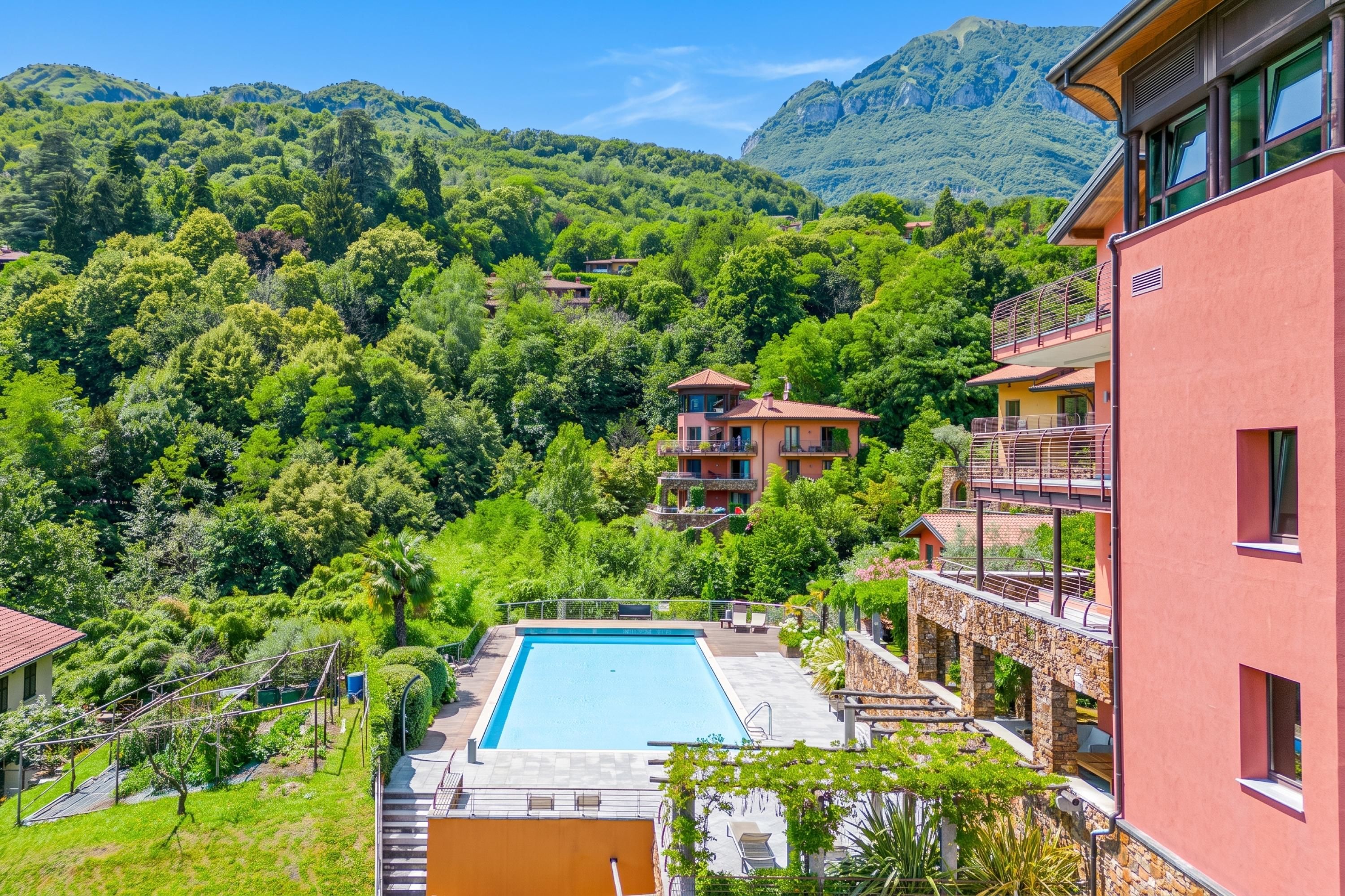 A pool area with a clear view of the surrounding lush greenery and mountains.