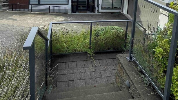 A modern two-story building with a flat roof, large windows, and a visible entrance. - Room-brand new 2 Bedrooms (District of North Vancouver)