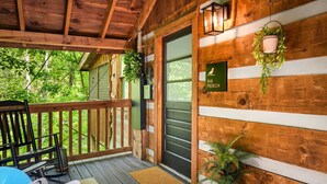 A wooden cabin with a porch, a sign reading 'The Perch,' and a door. - New Cozy Spa Cabin! Hot Tub, Sauna, Jacuzzi! 20% Off-New Listing Promotion! (Sevierville)