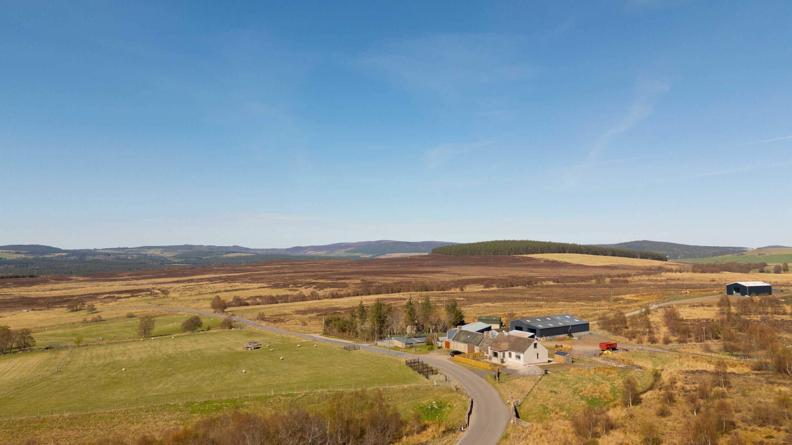 Lynemore Croft from above — nestled beside a working farm on the scenic Grantown-on-Spey to Tomintoul road, surrounded by open Highland countryside.
