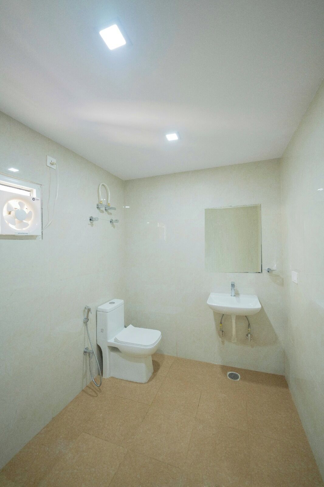 A bathroom with a toilet, sink, and shower.