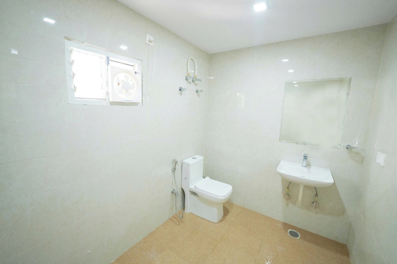 A bathroom with a toilet, sink, and shower.