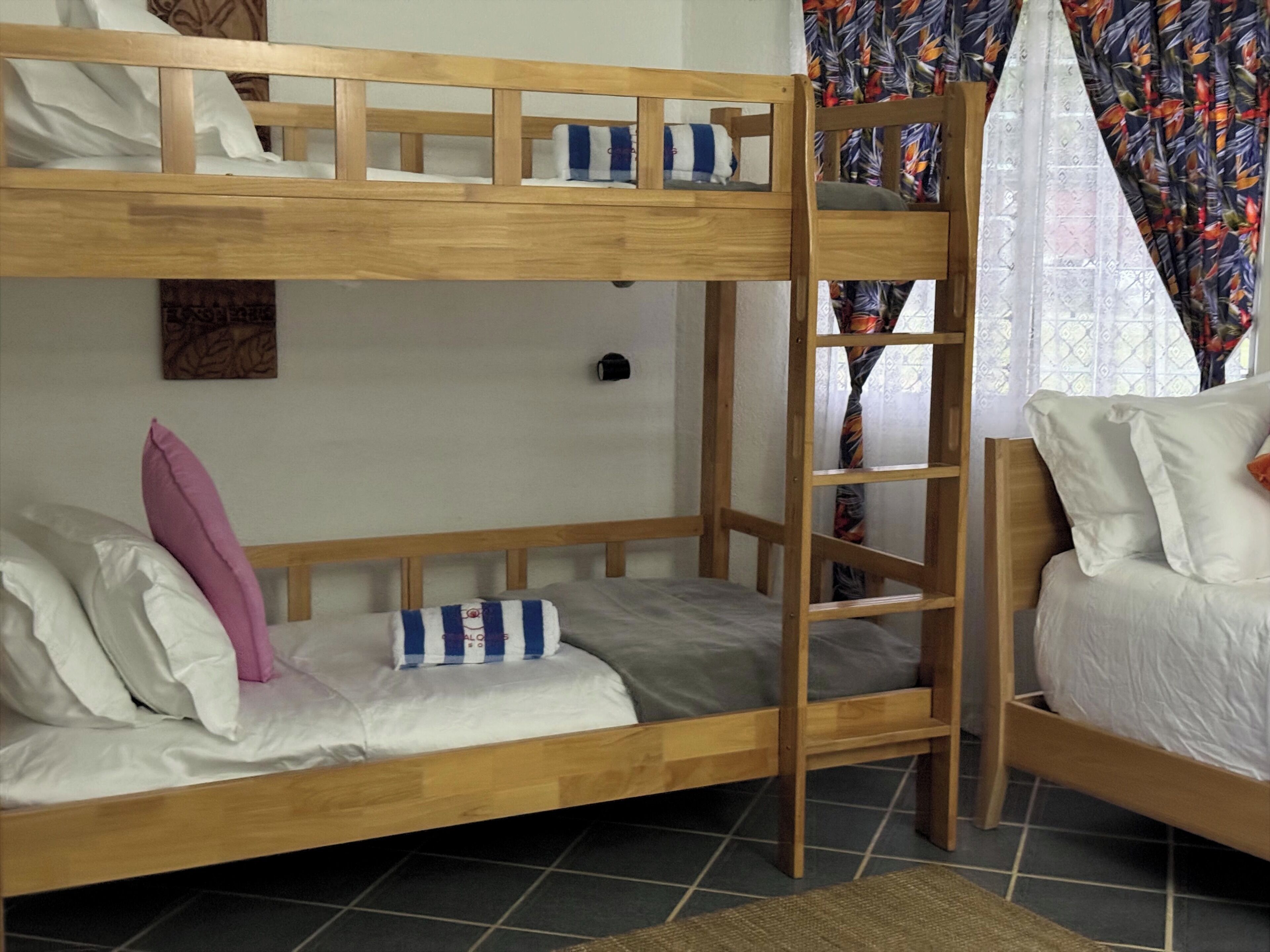 A bunk bed with a ladder, a pillow, and a blanket.