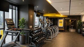 A gym with treadmills, dumbbells, and exercise machines.