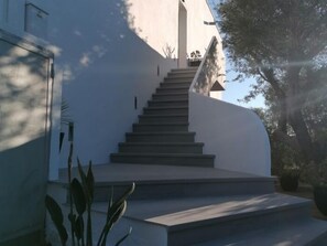 A modern building with a staircase leading to a door. - Condo in Roses · ★4.68 (Roses)